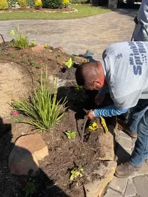 Mr Sprinkler Repair technician working on landscaping in Fort Worth TX